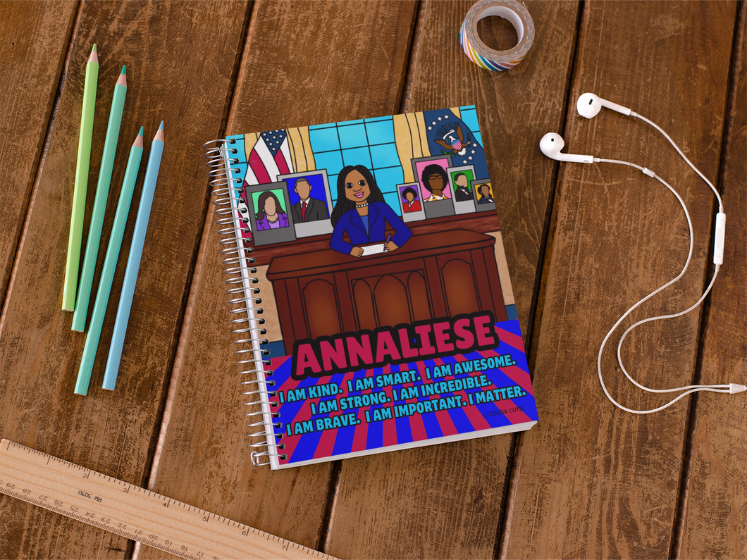 Black president girl in oval office surrounded by pictures of past black political pioneers. notebook contains positive affirmations on front and inside cover. Spiral notebook. Cocoa Cutie
