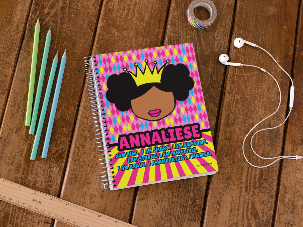 Black princess with tiara pink, yellow, and blue background. notebook contains positive affirmations on front and inside cover. Spiral notebook. Cocoa Cutie